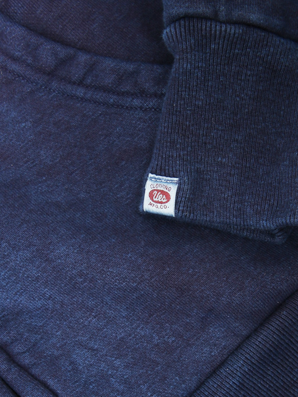 UES Indigo Zip Parka brand logo
