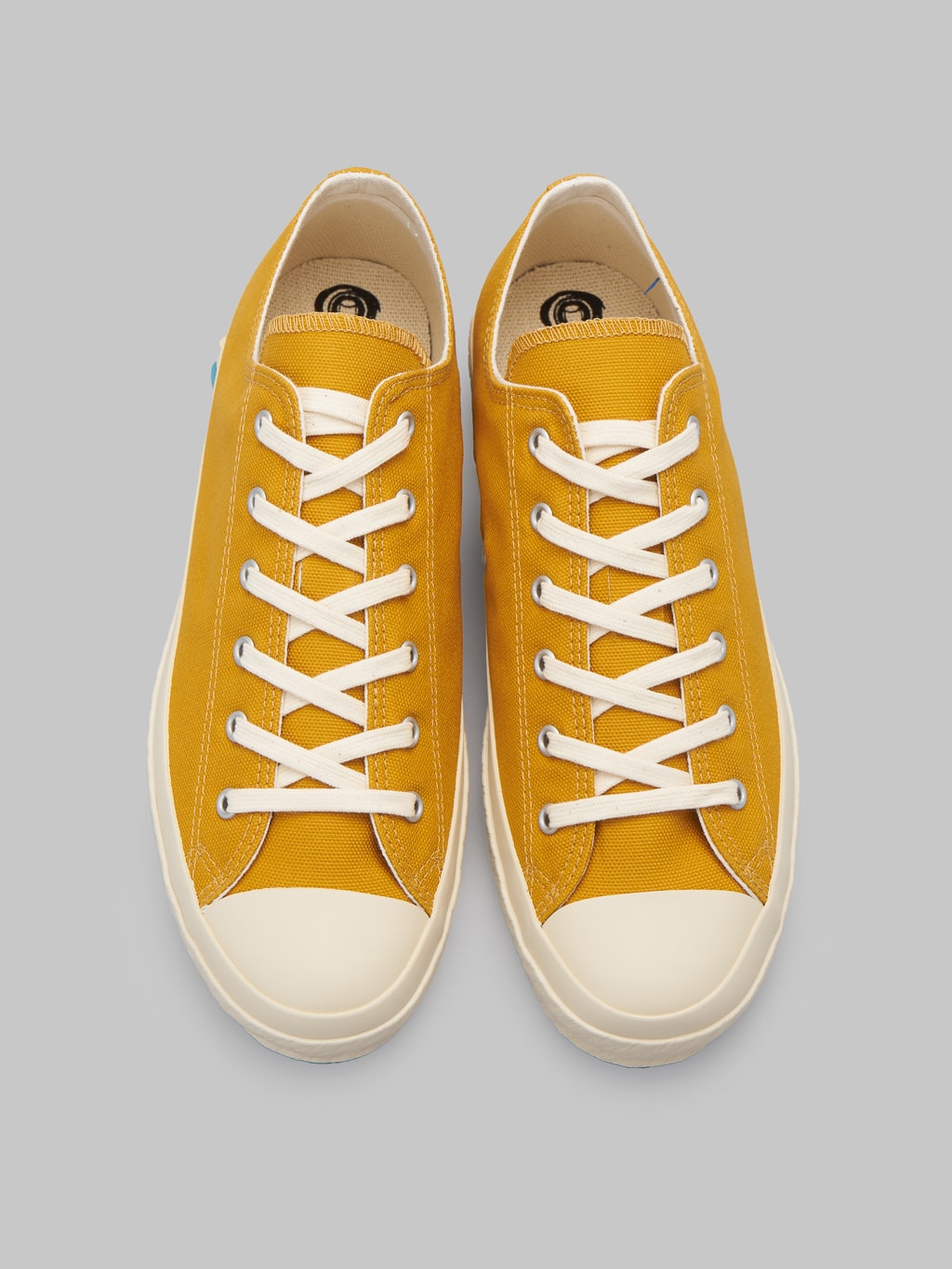 Shoes like pottery low mustard sneakers up view