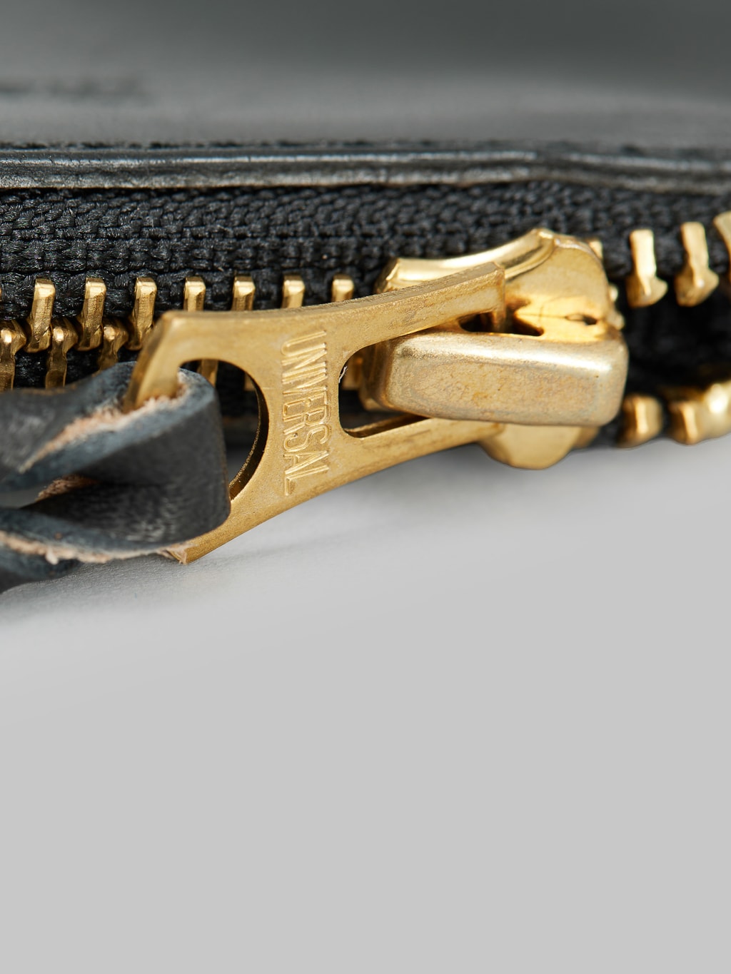 The Strike Gold Leather Zip Wallet Black close up detail