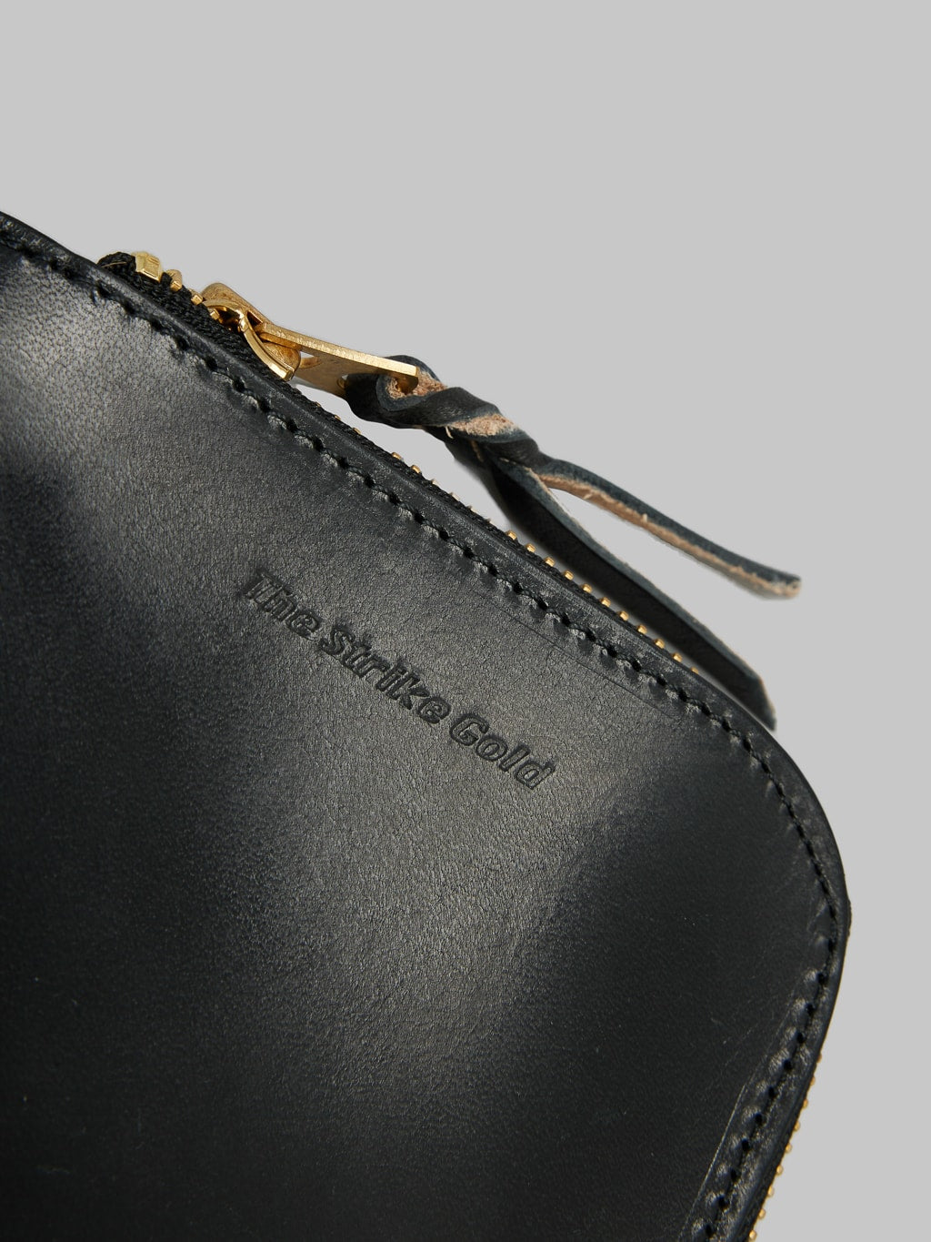 The Strike Gold Leather Zip Wallet Black artisanal engraved logo