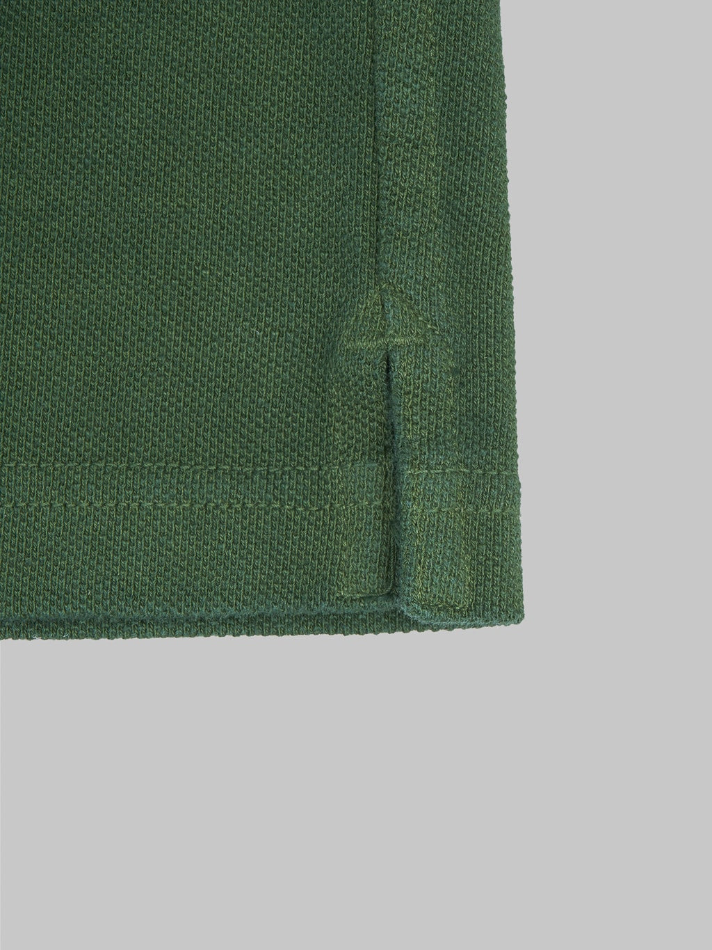 ues polo shirt green fabric closeup