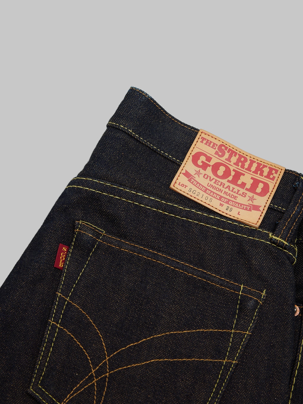 The Strike Gold Brown Weft Slim Jeans brand leather patch