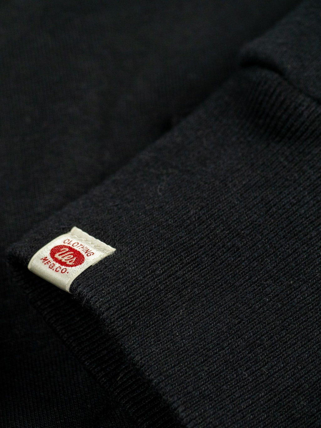 UES hoodie Zip Parka black cuff tag