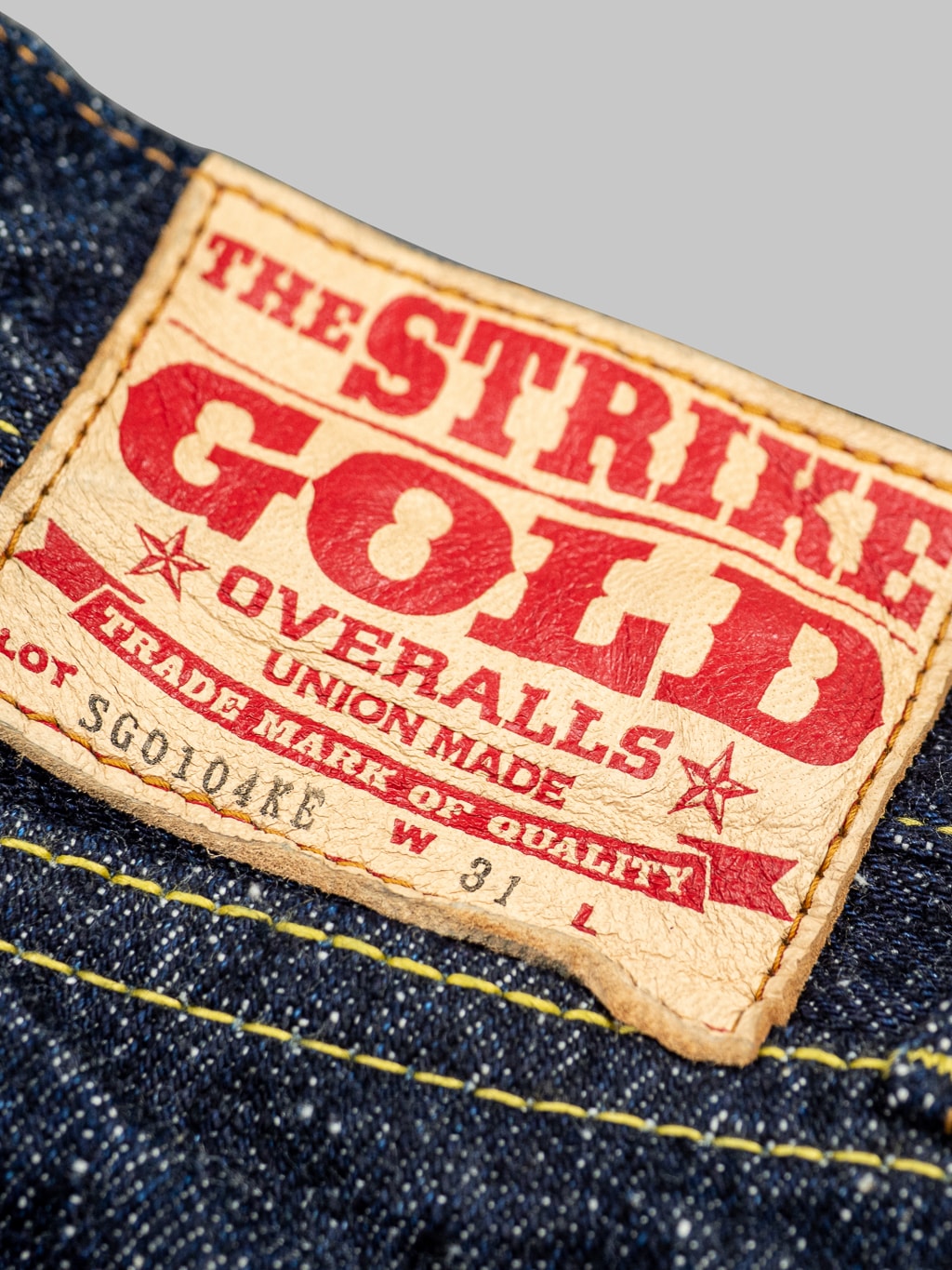The Strike Gold Keep Earth Natural Indigo Jeans brand leather patch
