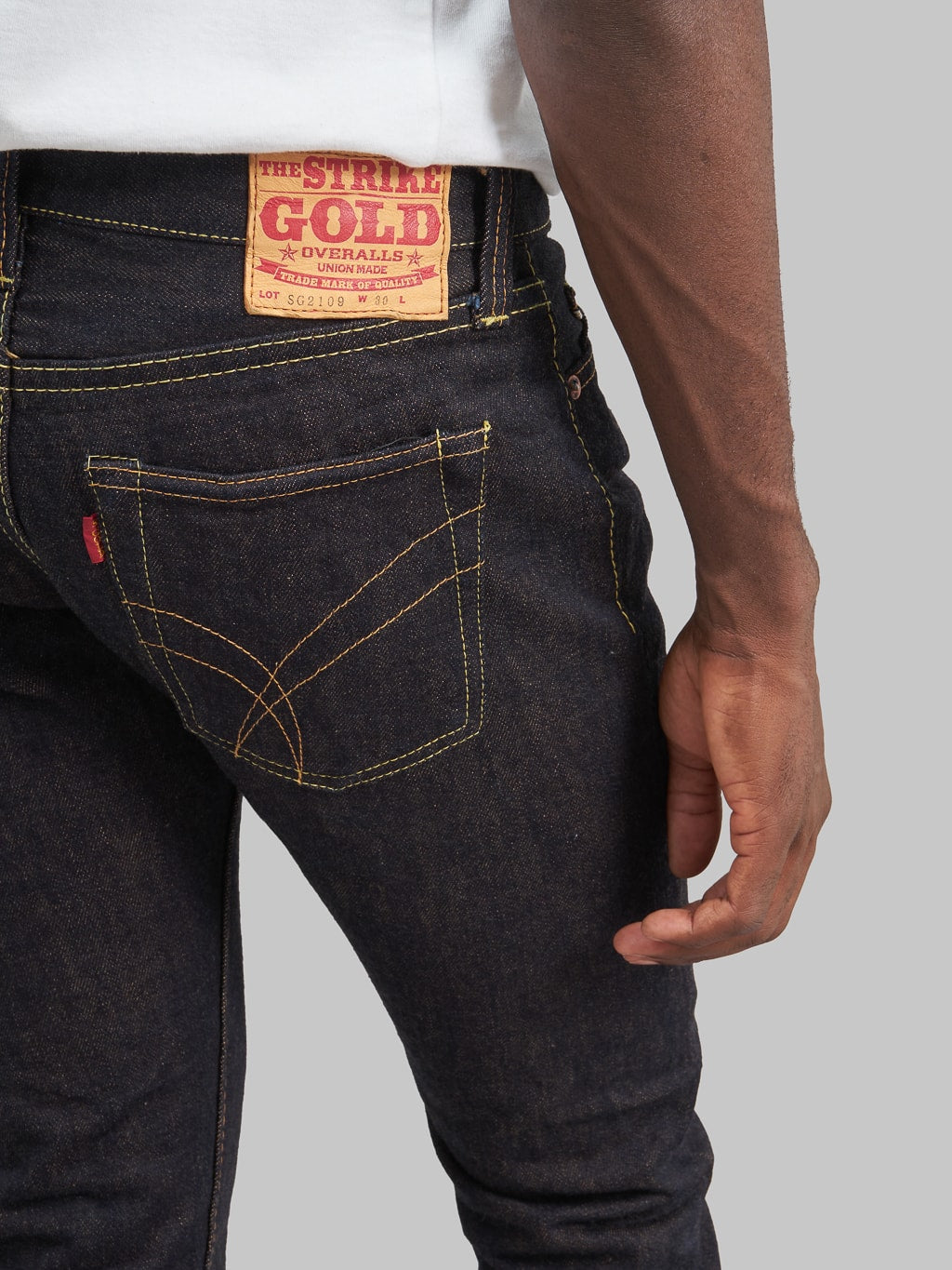 The Strike Gold Brown Weft Slim Tapered Jeans back pocket