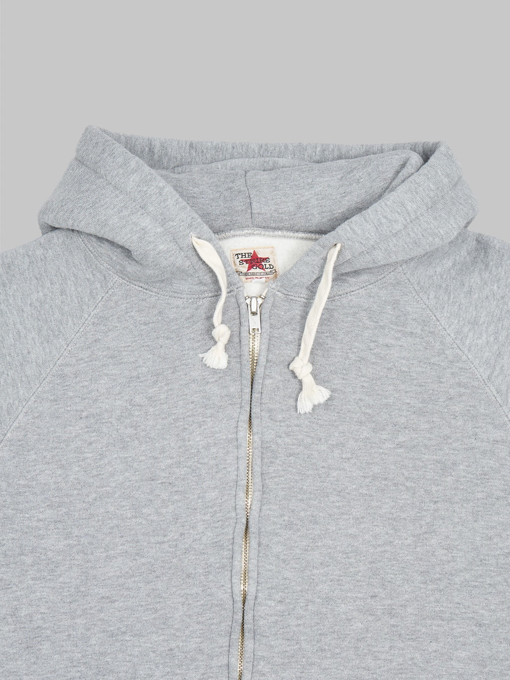 the strike gold zip hoodie grey front details