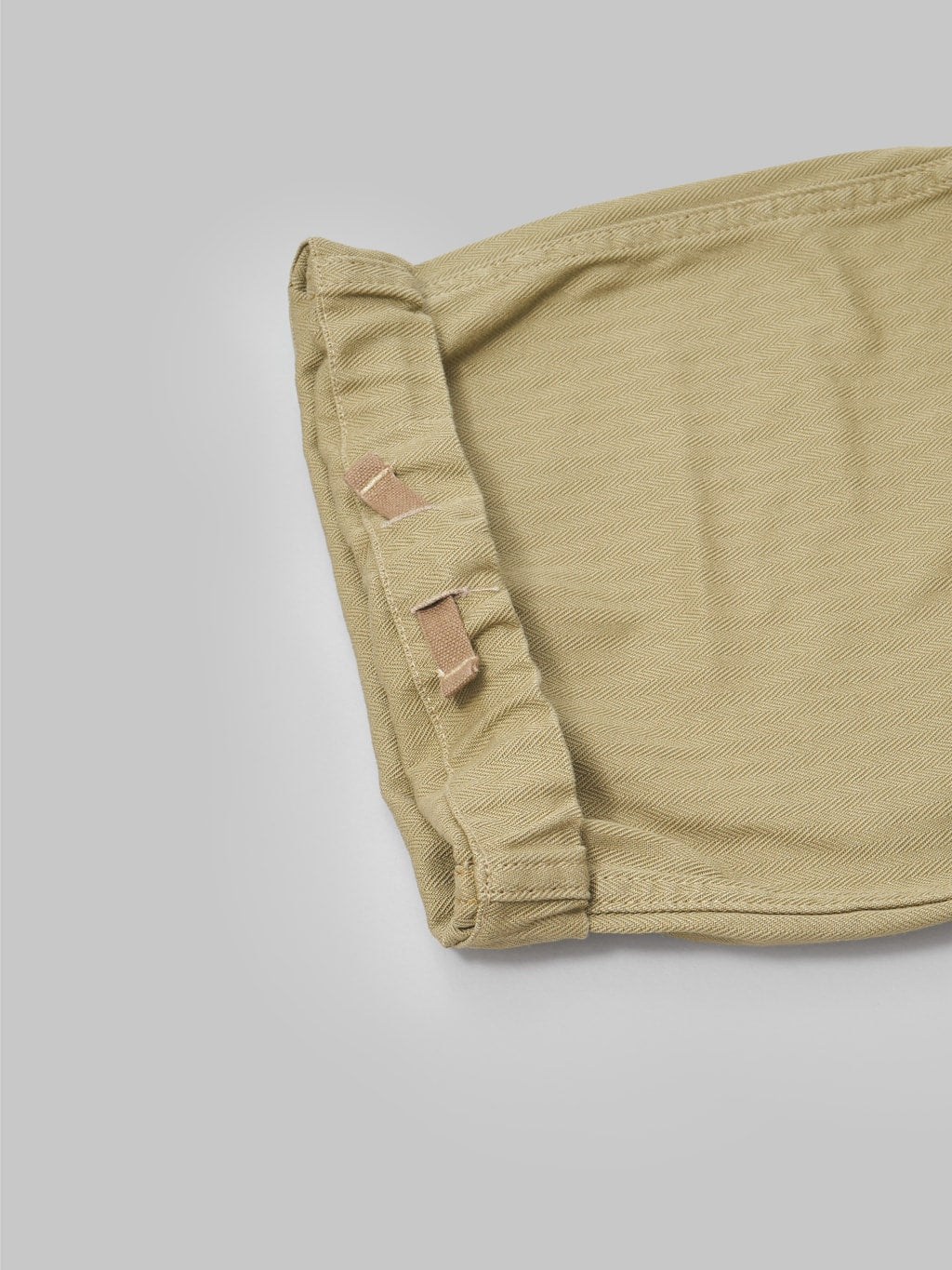 tanuki herringbone m65 pants khaki beige adjustable leg closeup