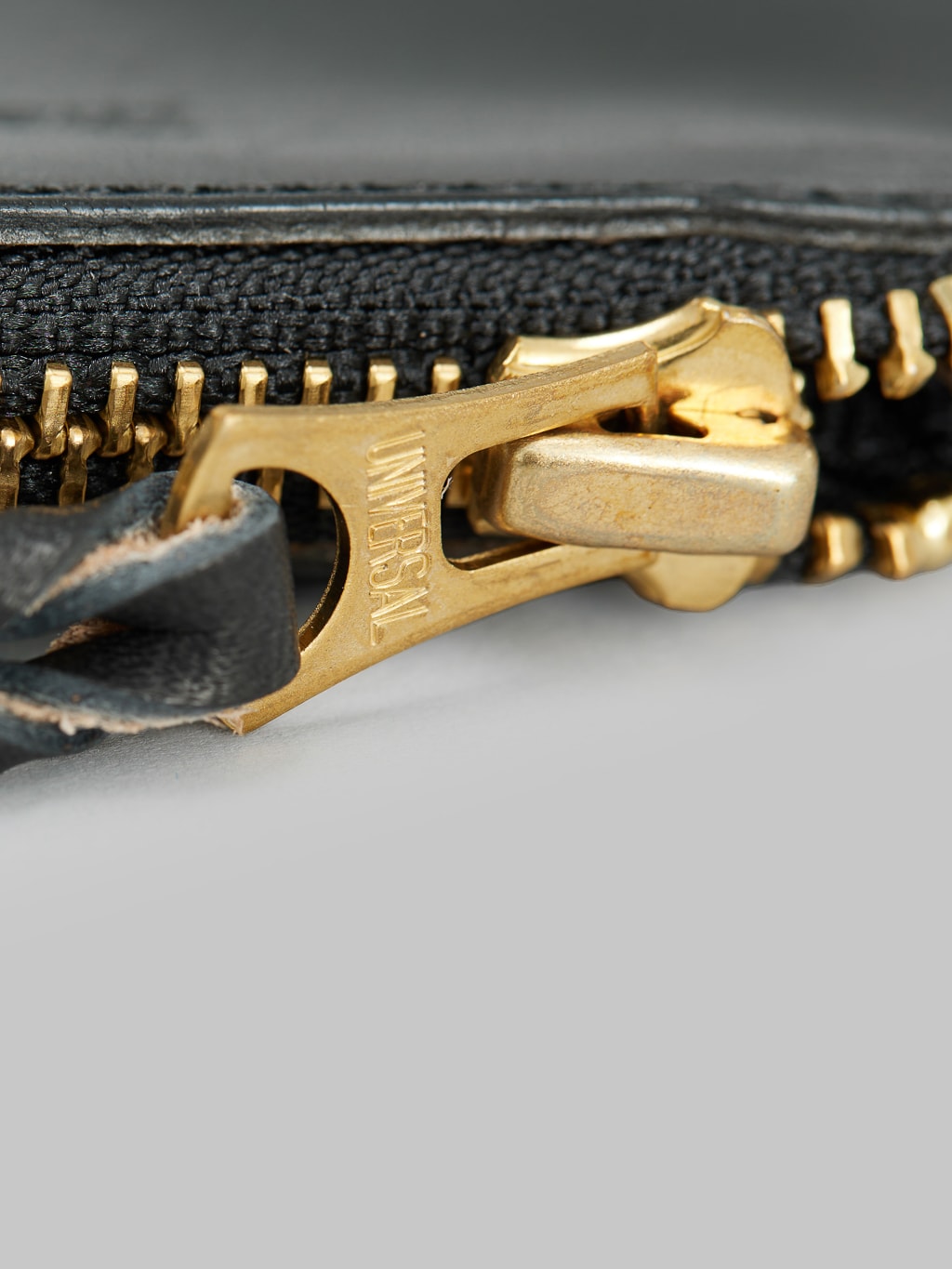 The Strike Gold Leather Zip Wallet Black close up detail 