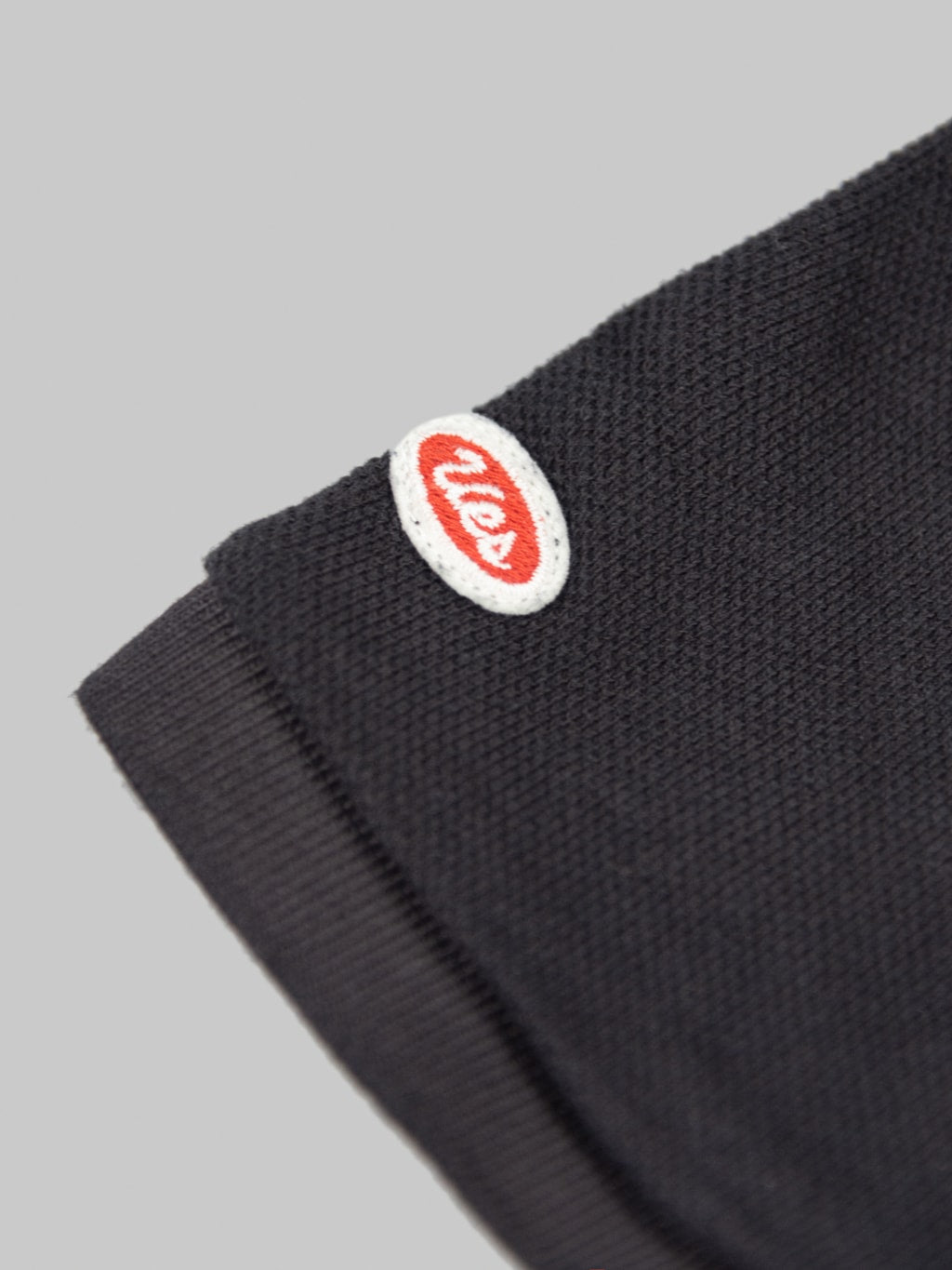 ues polo shirt black brand logo patch