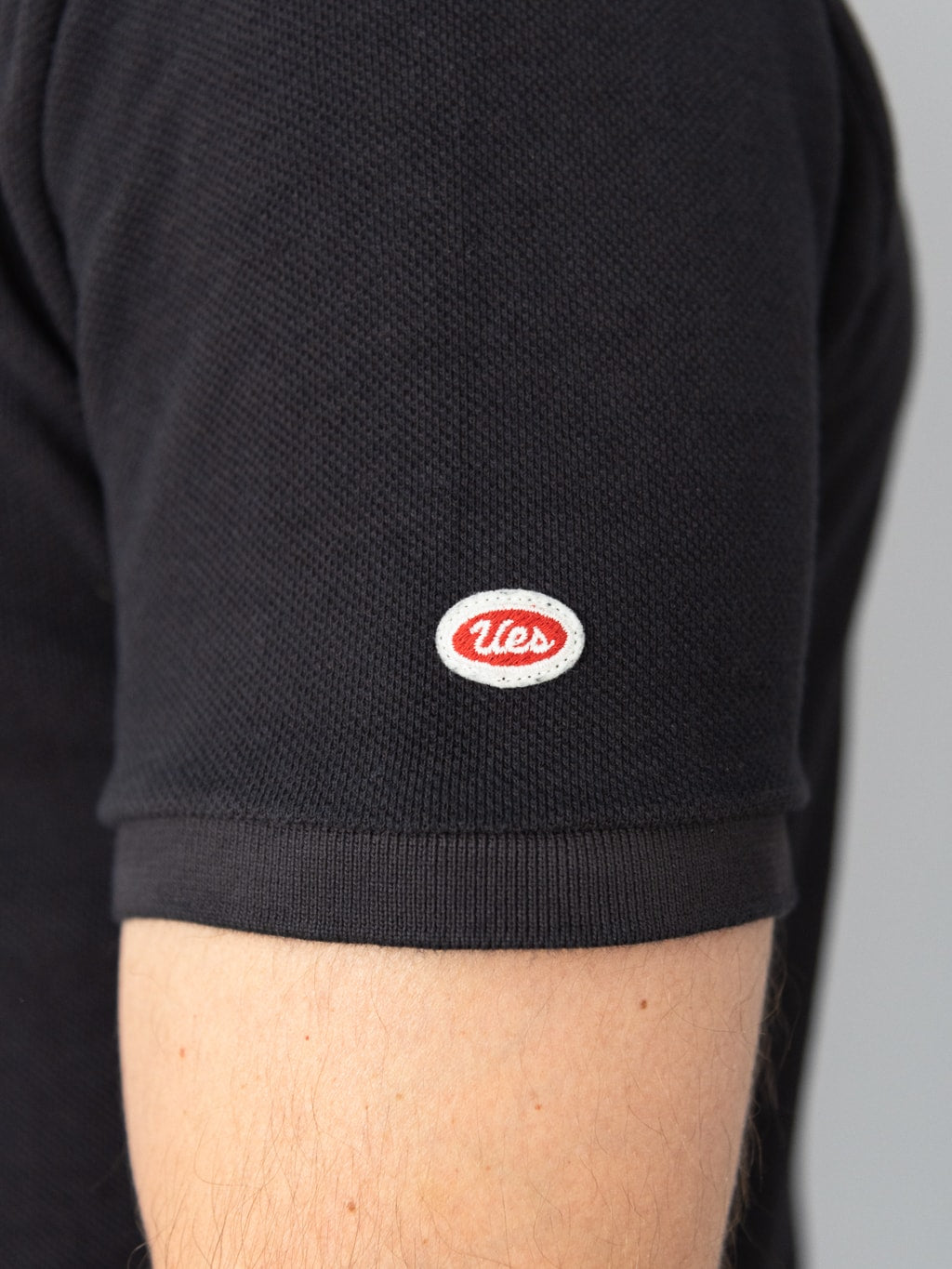 ues polo shirt black short sleeve logo patch